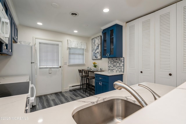 59B Cambridge Cir, Manchester, NJ 08759 - kitchen featuring blue cabinetry, a sink, white range, dark wood-type flooring, and glass insert cabinets