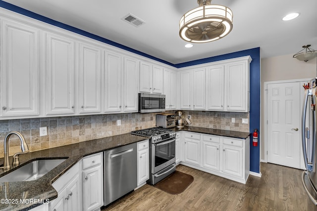 66 Shore Dr Unit 20, South Amboy, NJ 08879 - kitchen with stainless steel appliances, a sink, white cabinetry, decorative backsplash, and recessed lighting