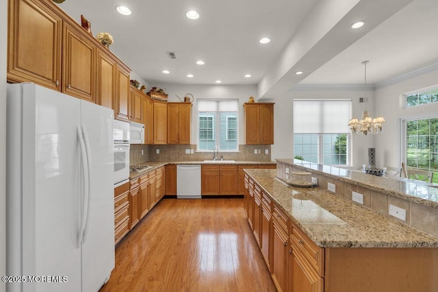 39 Barton Creek Rd, Jackson, NJ 08527 - kitchen with white appliances, tasteful backsplash, crown molding, light stone counters, and light wood-style floors