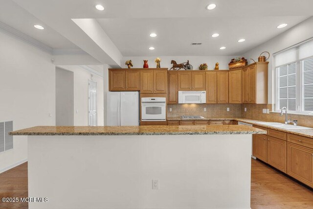 39 Barton Creek Rd, Jackson, NJ 08527 - kitchen featuring white appliances, a kitchen island, light stone countertops, backsplash, and recessed lighting
