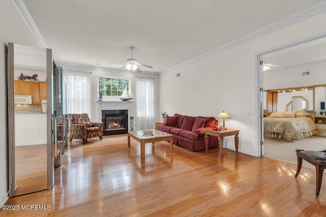 39 Barton Creek Rd, Jackson, NJ 08527 - living area featuring ceiling fan, light wood finished floors, a fireplace, and crown molding