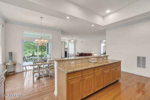 39 Barton Creek Rd, Jackson, NJ 08527 - kitchen featuring crown molding, light wood-style flooring, open floor plan, light stone counters, and a ceiling fan