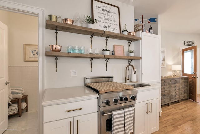 142 Heck Ave, Ocean Grove, NJ 07756 - kitchen featuring open shelves, high end stove, a sink, white cabinetry, and light countertops