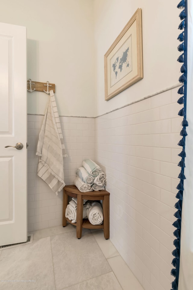 142 Heck Ave, Ocean Grove, NJ 07756 - bathroom featuring tile walls, tile patterned flooring, and wainscoting