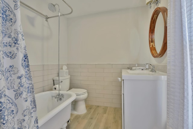 142 Heck Ave, Ocean Grove, NJ 07756 - full bath featuring tile walls, wood finished floors, toilet, vanity, and a wainscoted wall