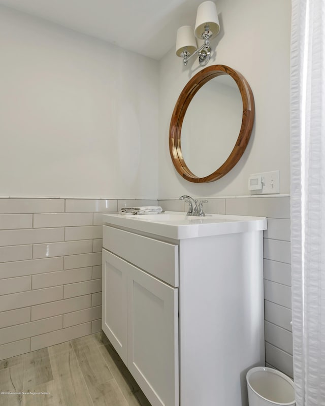 142 Heck Ave, Ocean Grove, NJ 07756 - bathroom with tile walls, vanity, wood finished floors, and wainscoting