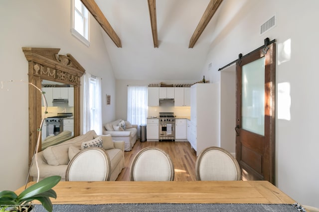142 Heck Ave, Ocean Grove, NJ 07756 - living room featuring beamed ceiling, a barn door, light wood-style flooring, and high vaulted ceiling