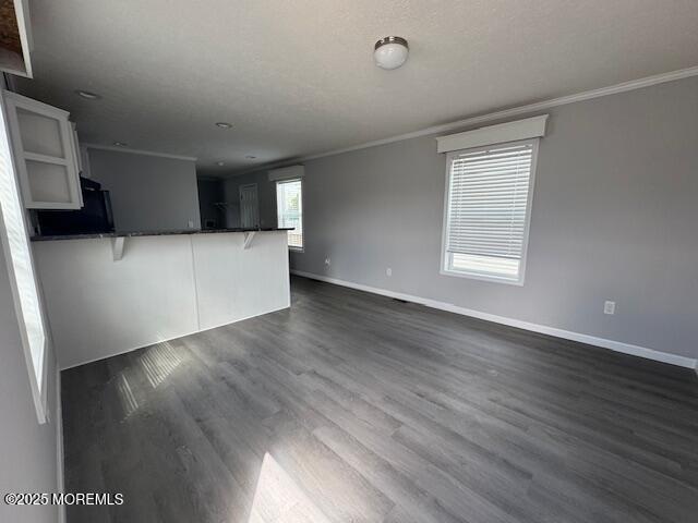 12 Mary Ann Ct, Hazlet, NJ 07734 - unfurnished living room featuring ornamental molding, baseboards, and dark wood finished floors