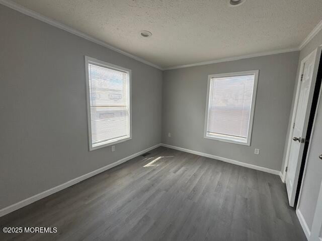 12 Mary Ann Ct, Hazlet, NJ 07734 - empty room featuring crown molding, dark wood finished floors, a textured ceiling, plenty of natural light, and baseboards