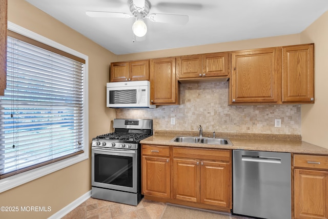 7 Juniper Ln, Jackson, NJ 08527 - kitchen with appliances with stainless steel finishes, a sink, tasteful backsplash, baseboards, and light countertops