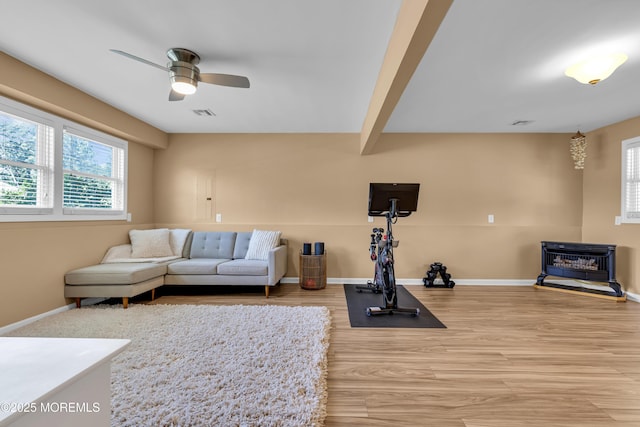 7 Juniper Ln, Jackson, NJ 08527 - living area featuring ceiling fan, a wood stove, wood finished floors, and baseboards