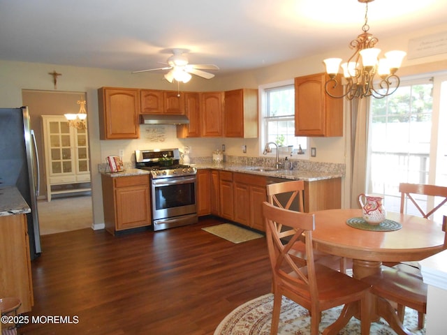 483 Coral Ln, Manahawkin, NJ 08050 - kitchen with stainless steel appliances, a chandelier, under cabinet range hood, dark wood-style flooring, and light stone countertops
