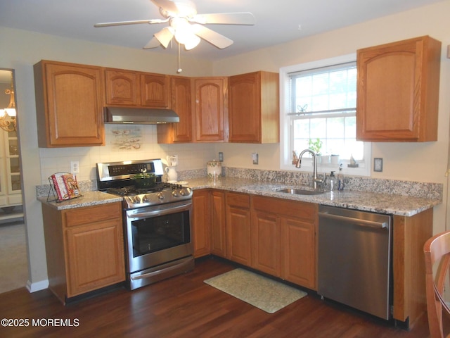 483 Coral Ln, Manahawkin, NJ 08050 - kitchen featuring appliances with stainless steel finishes, under cabinet range hood, light stone countertops, and dark wood-type flooring