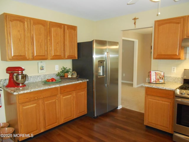 483 Coral Ln, Manahawkin, NJ 08050 - kitchen with appliances with stainless steel finishes, light stone counters, dark wood-type flooring, decorative backsplash, and extractor fan