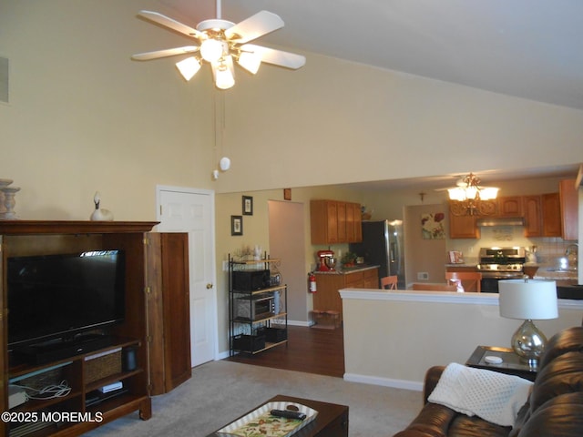 483 Coral Ln, Manahawkin, NJ 08050 - living area featuring high vaulted ceiling, a ceiling fan, dark colored carpet, and a chandelier