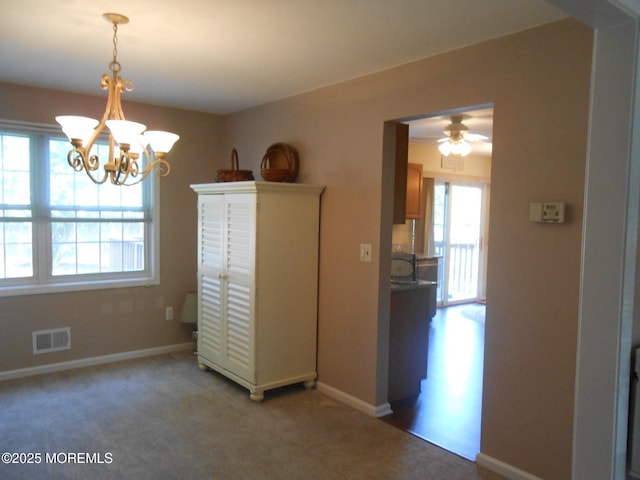 483 Coral Ln, Manahawkin, NJ 08050 - dining area featuring a chandelier, carpet flooring, and ceiling fan