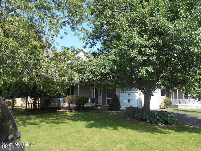 483 Coral Ln, Manahawkin, NJ 08050 - view of property hidden behind natural elements with a porch, asphalt driveway, a front lawn, and a garage