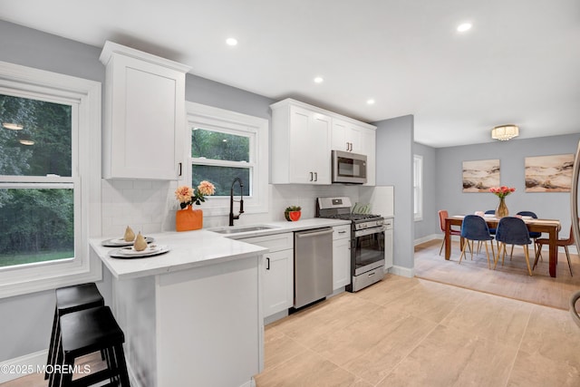 1172 Concord Dr, Brick, NJ 08724 - kitchen with appliances with stainless steel finishes, a sink, tasteful backsplash, white cabinetry, and recessed lighting