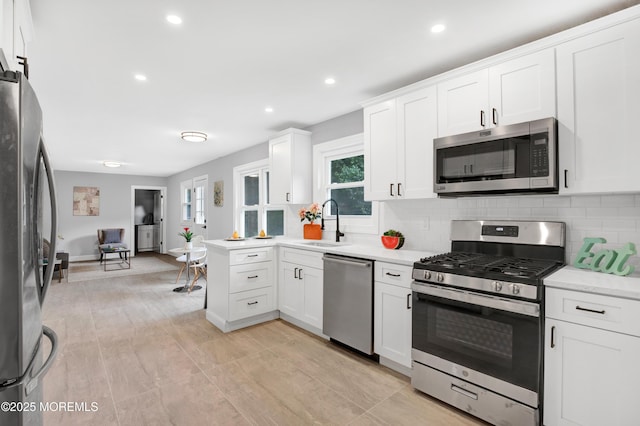 1172 Concord Dr, Brick, NJ 08724 - kitchen featuring appliances with stainless steel finishes, a sink, tasteful backsplash, white cabinets, and recessed lighting