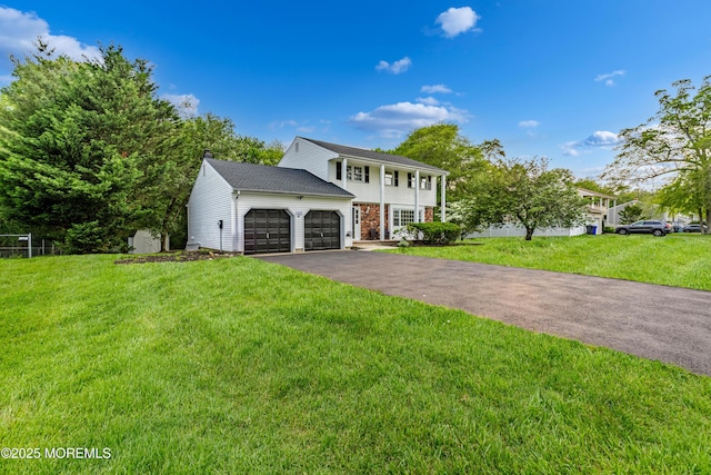 1172 Concord Dr, Brick, NJ 08724 - colonial home featuring a garage, driveway, and a front lawn