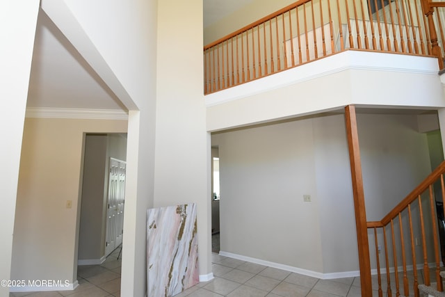 6 Marc Ln, North Hanover, NJ 08562 - staircase with tile patterned flooring, crown molding, baseboards, and a towering ceiling