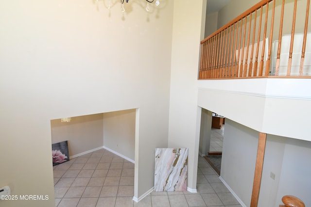 6 Marc Ln, North Hanover, NJ 08562 - laundry area with tile patterned flooring, baseboards, a chandelier, and a towering ceiling