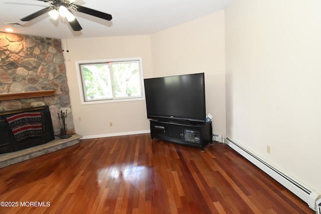 6 Marc Ln, North Hanover, NJ 08562 - unfurnished living room with baseboard heating, a ceiling fan, wood finished floors, a fireplace, and baseboards