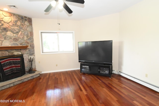 6 Marc Ln, North Hanover, NJ 08562 - unfurnished living room featuring baseboard heating, wood-type flooring, ceiling fan, baseboards, and a fireplace