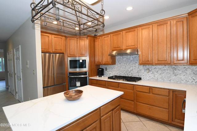 6 Marc Ln, North Hanover, NJ 08562 - kitchen with appliances with stainless steel finishes, under cabinet range hood, brown cabinetry, backsplash, and recessed lighting