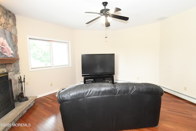 6 Marc Ln, North Hanover, NJ 08562 - living area with wood finished floors, a fireplace, a ceiling fan, and baseboard heating