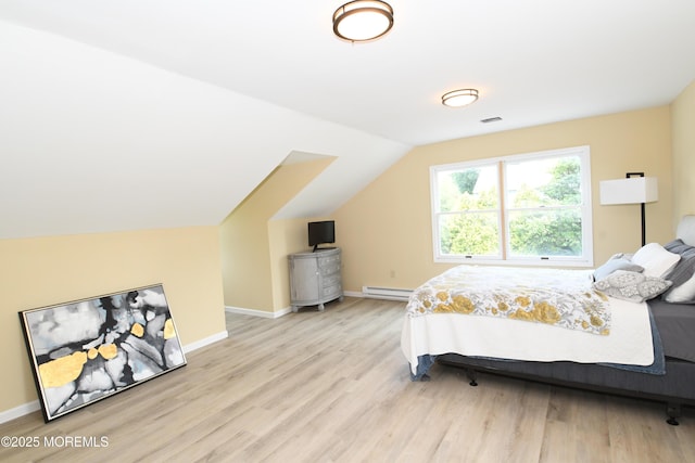 6 Marc Ln, North Hanover, NJ 08562 - bedroom with light wood-style flooring, a baseboard heating unit, and vaulted ceiling
