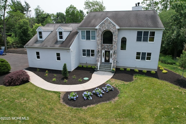6 Marc Ln, North Hanover, NJ 08562 - view of front of property with a front lawn, stone siding, a chimney, and a shingled roof