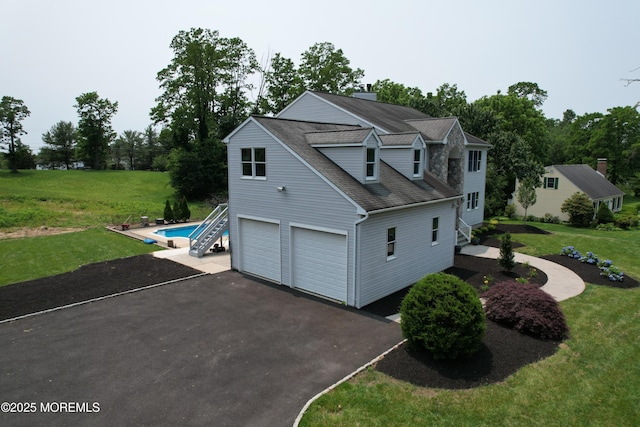 6 Marc Ln, North Hanover, NJ 08562 - view of property exterior with asphalt driveway, an attached garage, a lawn, and a shingled roof