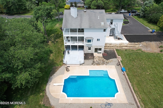 6 Marc Ln, North Hanover, NJ 08562 - rear view of house with a patio, stairs, a chimney, an outdoor pool, and a shingled roof