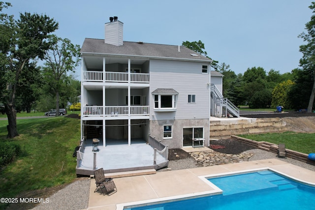 6 Marc Ln, North Hanover, NJ 08562 - back of house with a patio, a yard, a chimney, a balcony, and an outdoor pool