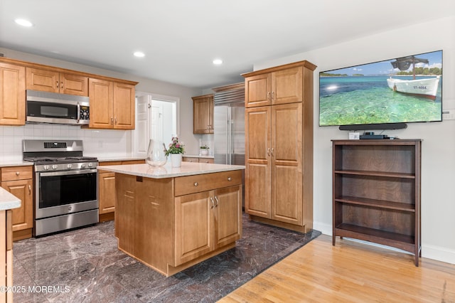 34 Peach Tree Ln, Little Silver, NJ 07739 - kitchen featuring stainless steel appliances, a kitchen island, recessed lighting, backsplash, and light stone countertops