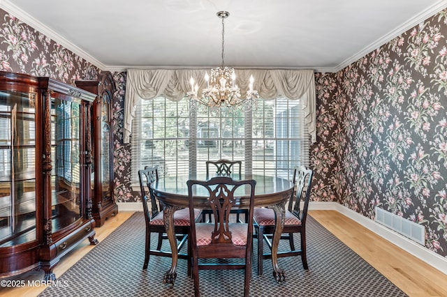 34 Peach Tree Ln, Little Silver, NJ 07739 - dining space with wallpapered walls, a chandelier, light wood-type flooring, and crown molding