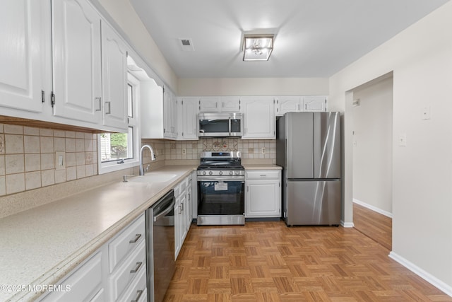 1776 Buttonwood Ave, Toms River, NJ 08755 - kitchen with stainless steel appliances, a sink, baseboards, white cabinets, and light countertops