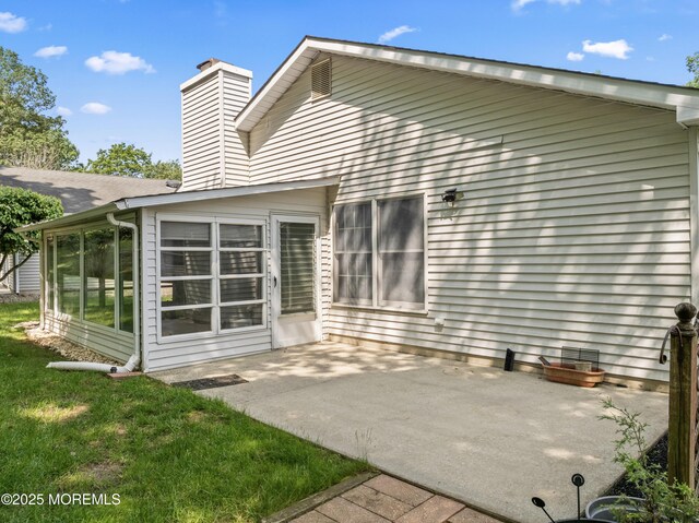 1776 Buttonwood Ave, Toms River, NJ 08755 - back of property with a patio, a chimney, and a sunroom
