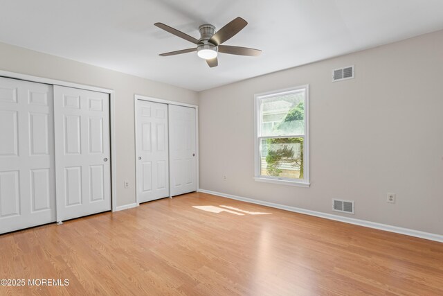 1776 Buttonwood Ave, Toms River, NJ 08755 - unfurnished bedroom with multiple closets, light wood-type flooring, baseboards, and ceiling fan