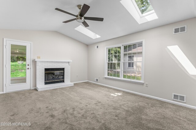 1776 Buttonwood Ave, Toms River, NJ 08755 - unfurnished living room featuring a skylight, lofted ceiling, a brick fireplace, carpet, and ceiling fan