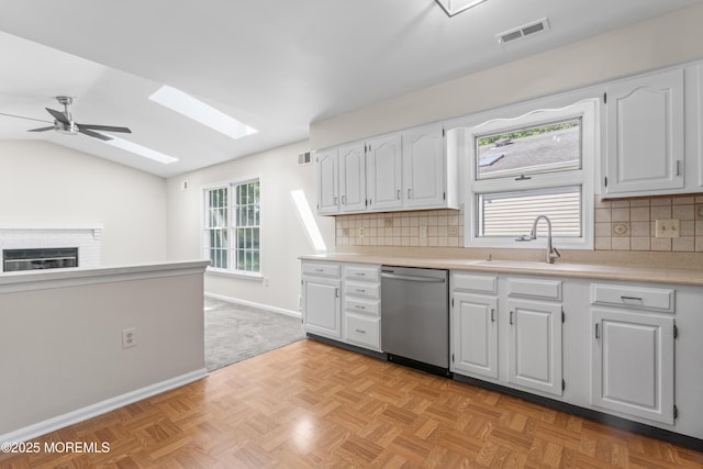 1776 Buttonwood Ave, Toms River, NJ 08755 - kitchen with dishwasher, a skylight, a sink, a ceiling fan, and white cabinets