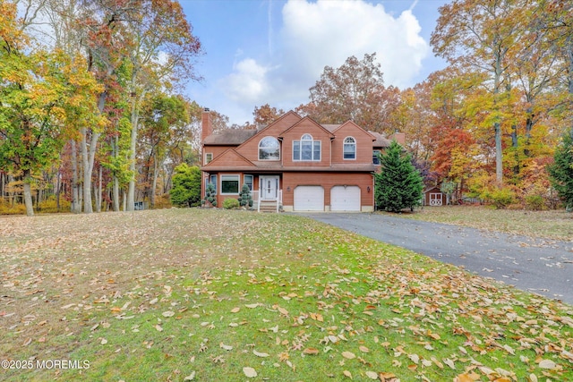 9 Rutherford Ct, Jackson, NJ 08527 - traditional home featuring a chimney, a garage, driveway, and a front yard