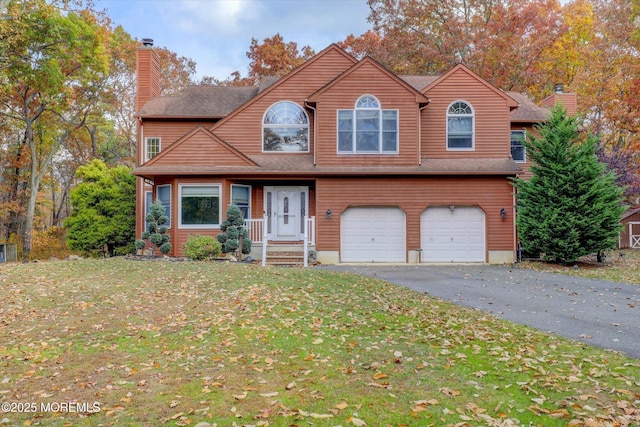 9 Rutherford Ct, Jackson, NJ 08527 - view of front facade featuring a chimney, an attached garage, a front lawn, and asphalt driveway