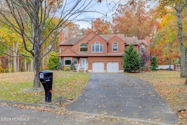9 Rutherford Ct, Jackson, NJ 08527 - view of front of home featuring a chimney, driveway, a garage, and a front lawn