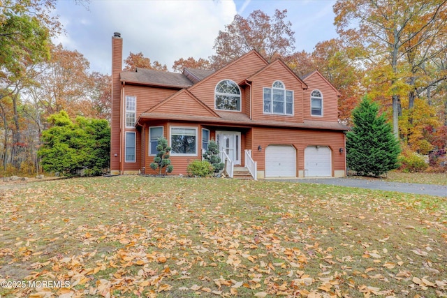 9 Rutherford Ct, Jackson, NJ 08527 - traditional-style home featuring an attached garage, a chimney, asphalt driveway, a front yard, and entry steps
