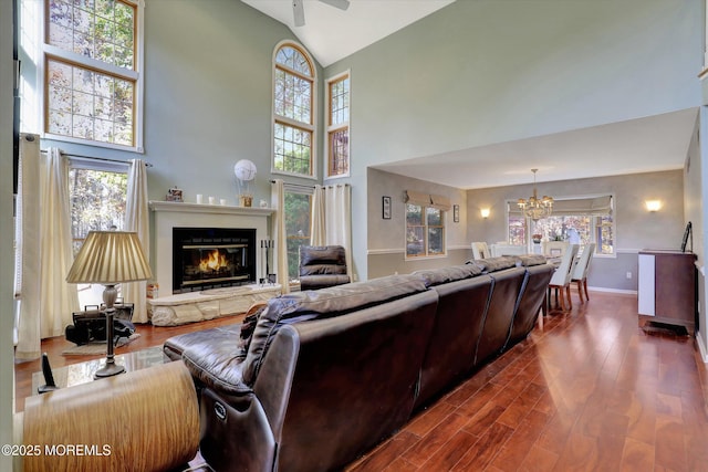 9 Rutherford Ct, Jackson, NJ 08527 - living area featuring high vaulted ceiling, a chandelier, dark wood-type flooring, a glass covered fireplace, and baseboards