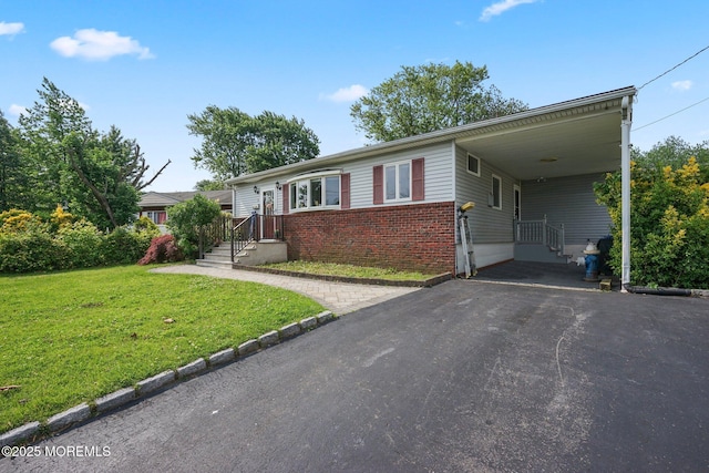 9 W Susan St, Hazlet, NJ 07730 - ranch-style house featuring asphalt driveway, brick siding, a front yard, and an attached carport
