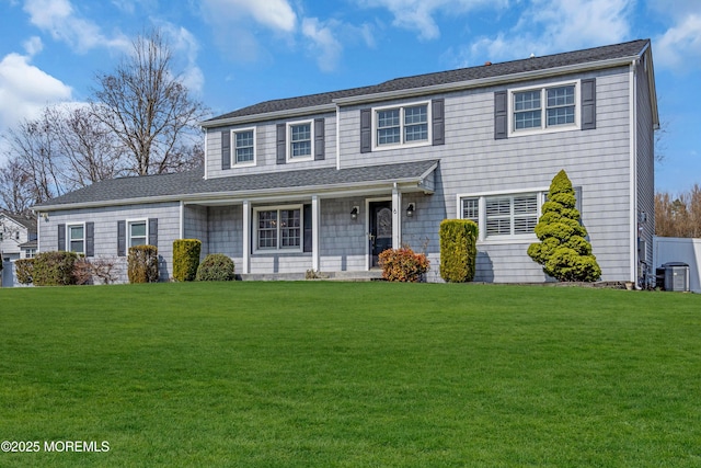 6 Kenneth Dr, Ocean Twp, NJ 07712 - view of front of house featuring central AC unit, a front lawn, and a porch
