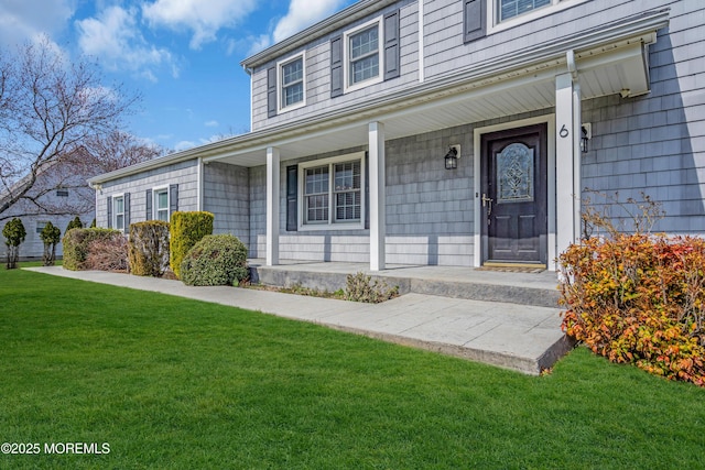 6 Kenneth Dr, Ocean Twp, NJ 07712 - property entrance with covered porch and a yard